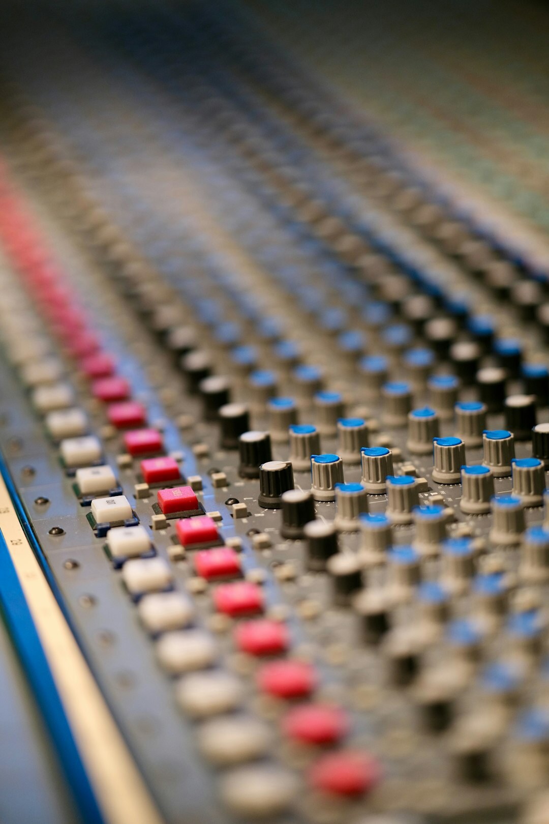 Audio mixing console with sliders in broadcast studio