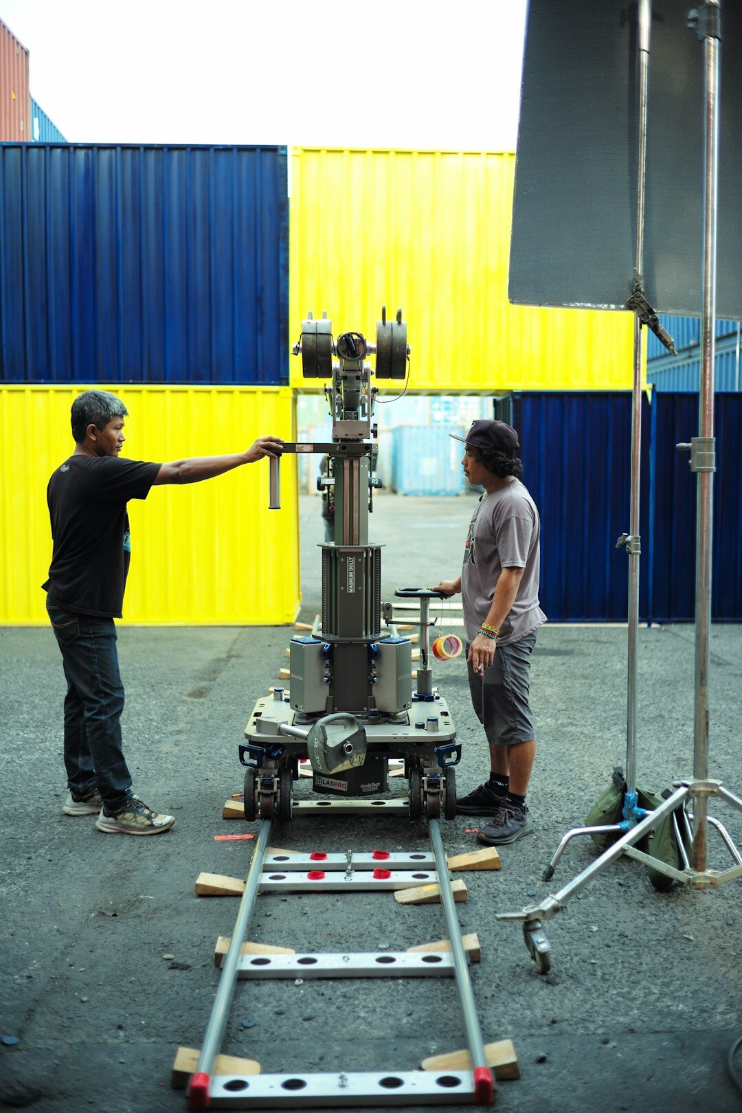 Crew setting up a robotic television camera on tracks